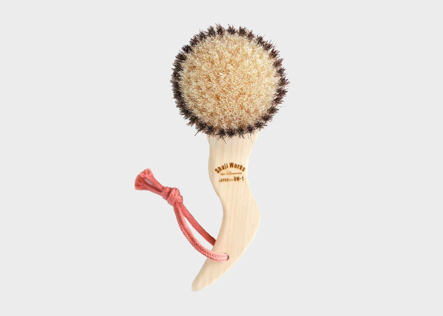 Shoji Works hand held short body brush in a light wood color with a pink rope string as sold by Woodland Mod
