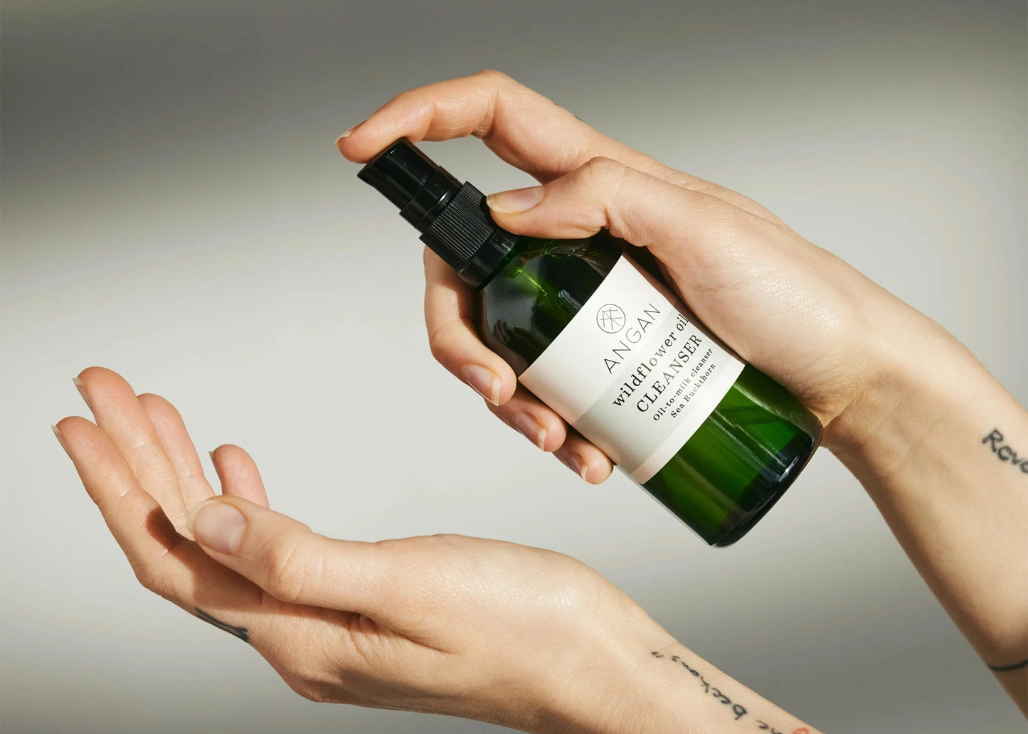Wildflower Oil Cleanser by Angan from Iceland being squirted onto a hand