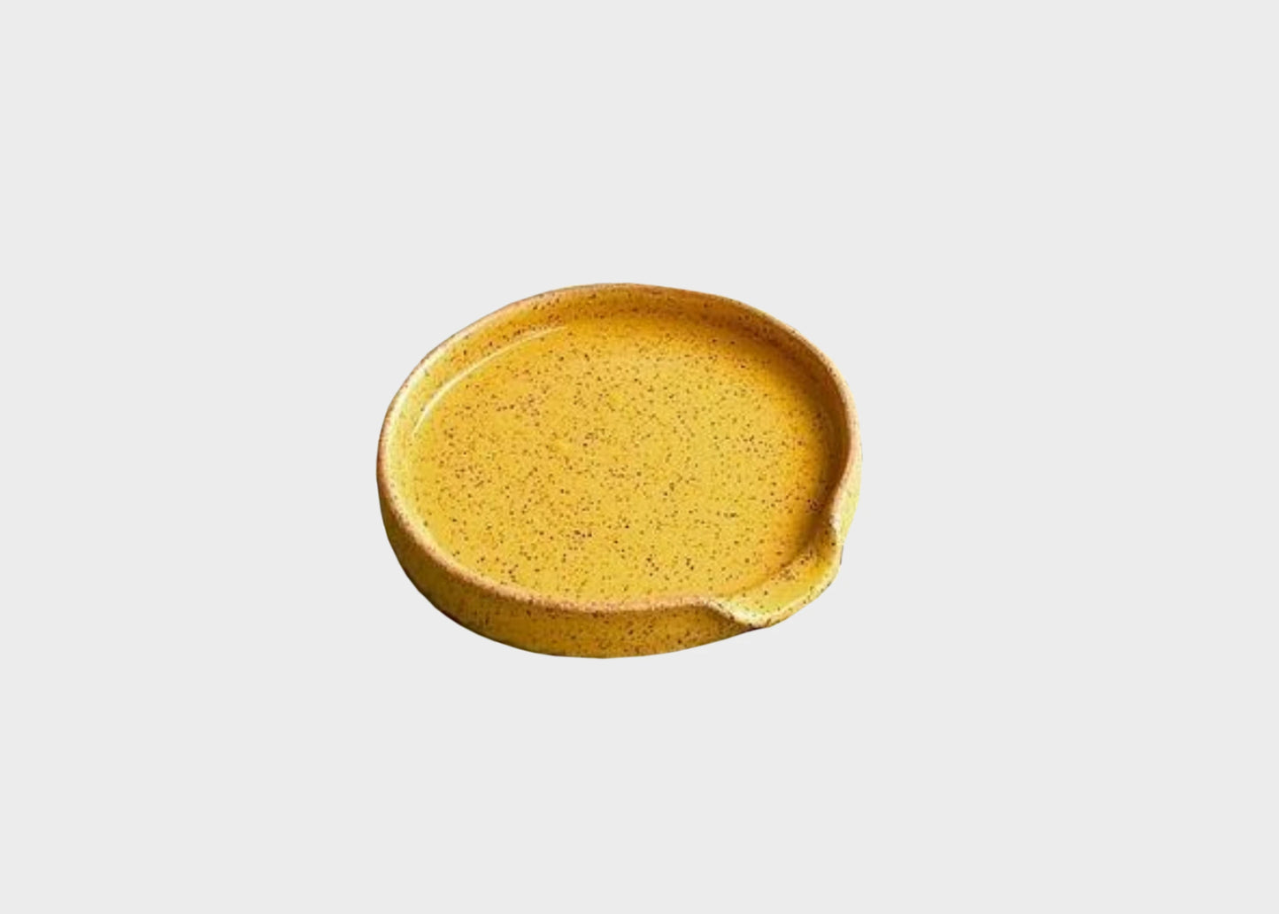 A yellow ceramic spoon rest by BYUN ceramics as sold by Woodland Mod
