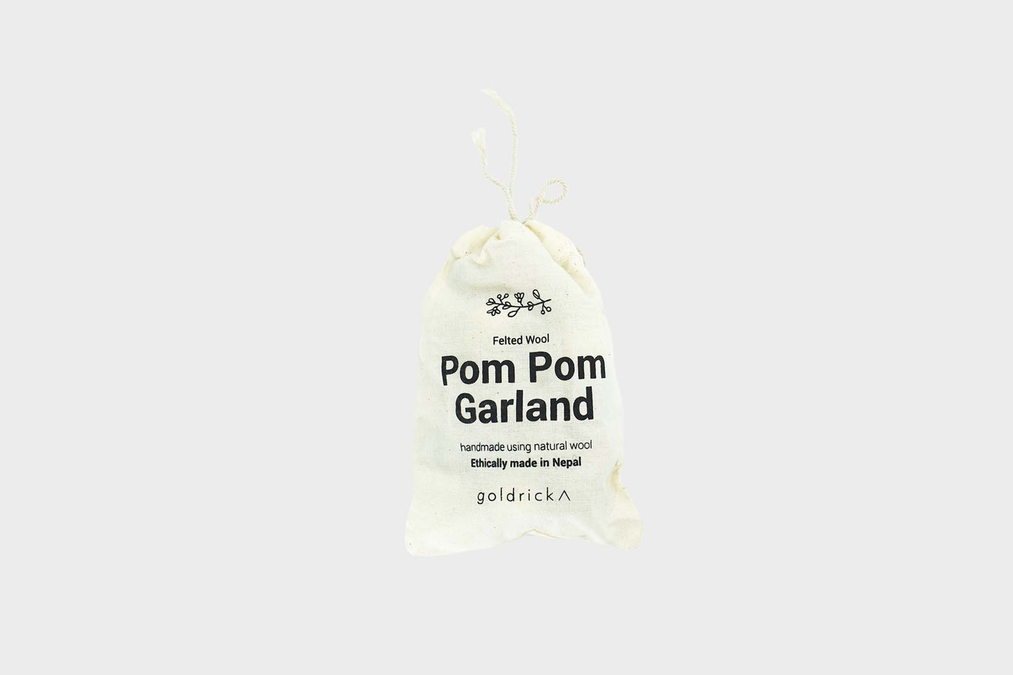Rainbow colored Pom Pom garland by Goldrick in a mesh bag