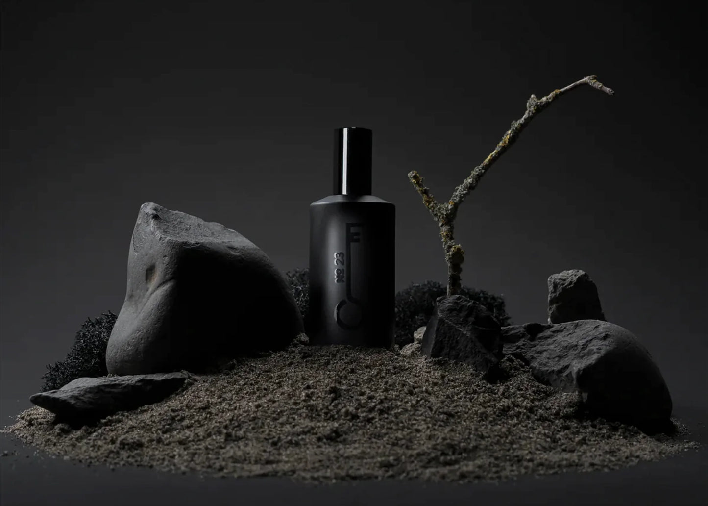 Fischersund perfume scent No. 23 in a 50ml black perfume bottle surrounded by rocks and dirt