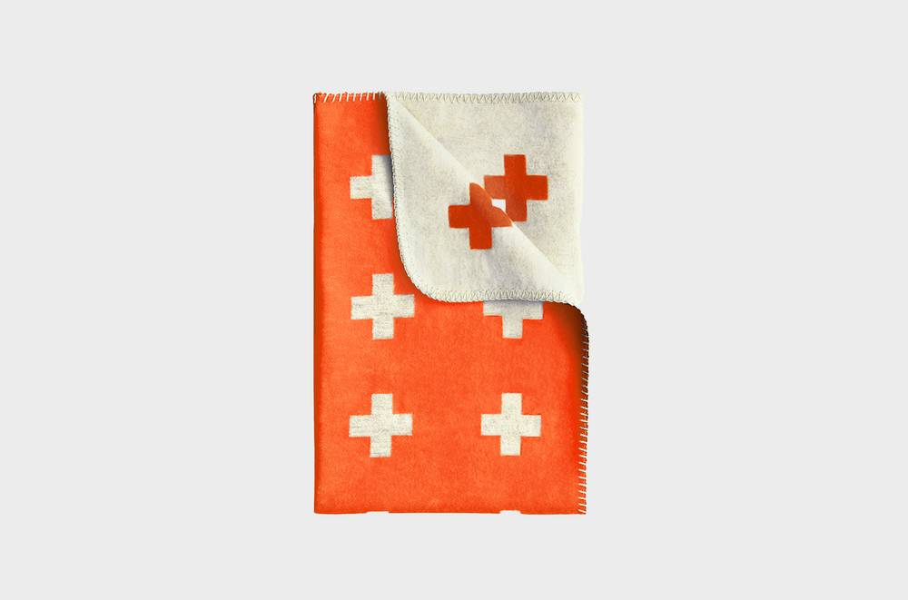 An orange blanket with crosses on it by Pia Wallen