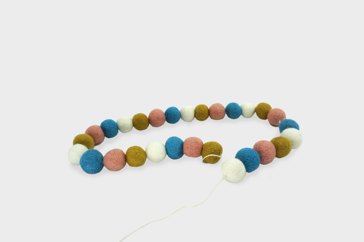 Rainbow colored Pom Pom garland by Goldrick