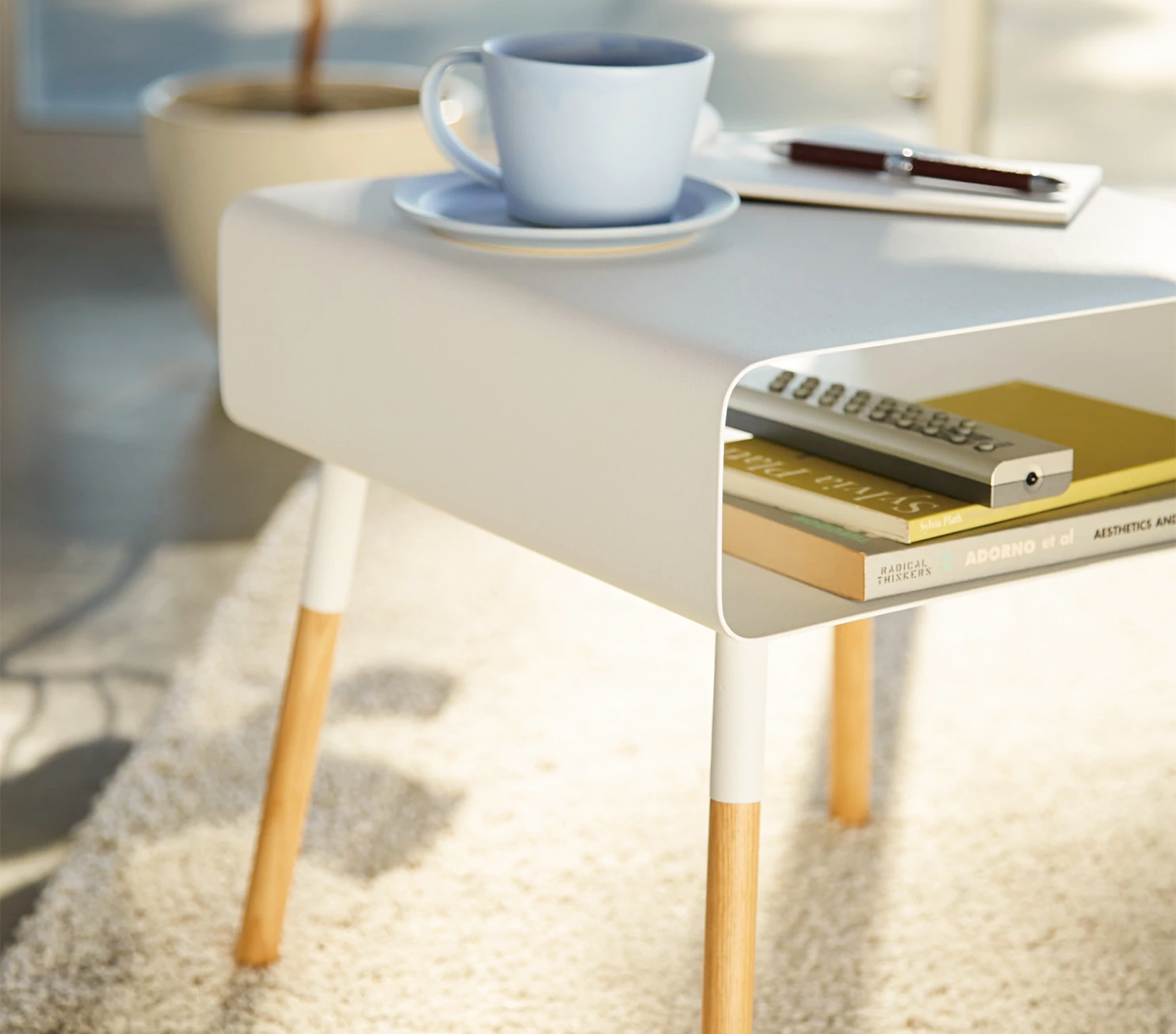Short White Storage Table by Yamazaki with a coffee cup and books on the surface