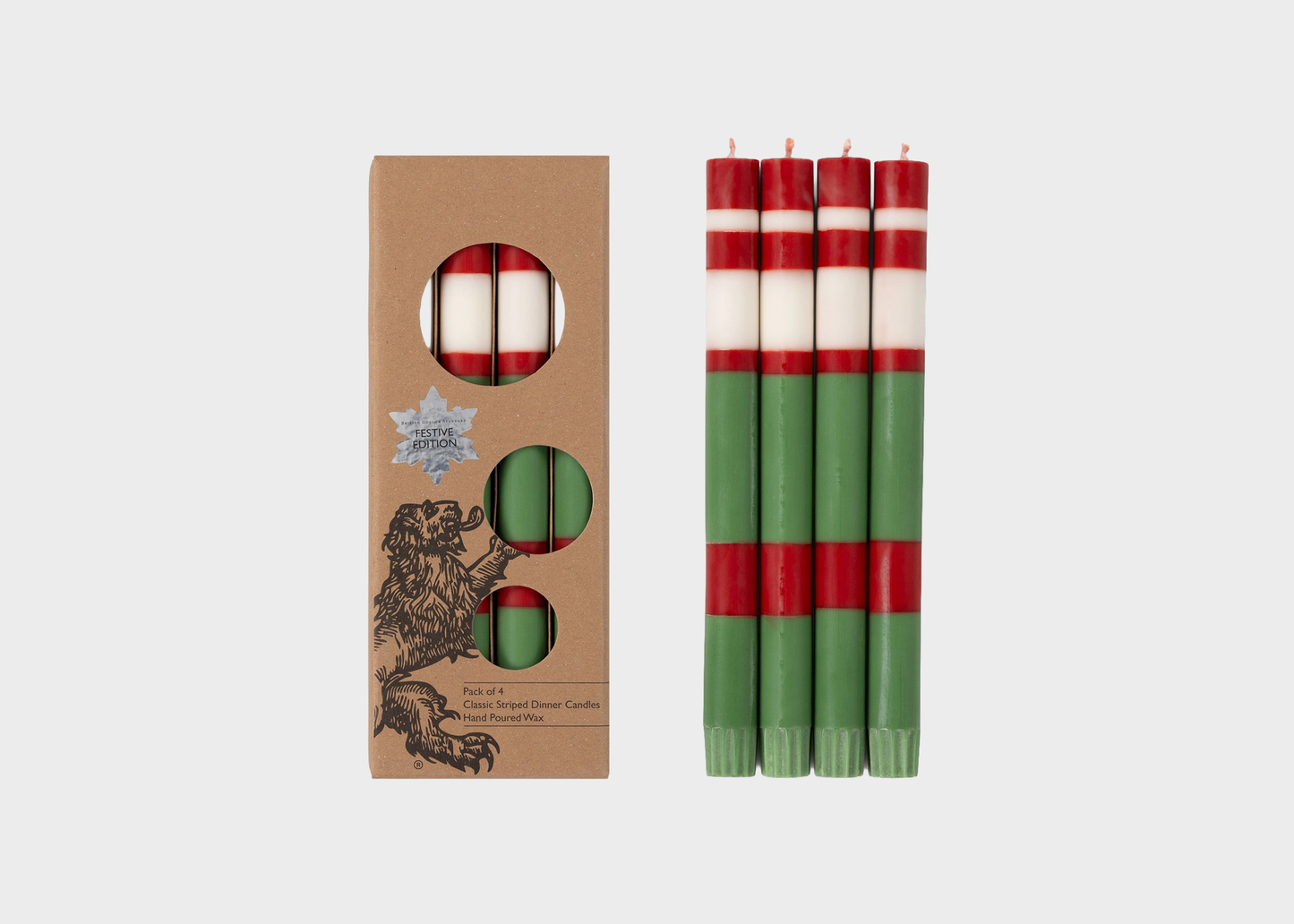 
                  
                    A set of four striped taper candles shown next to their kraft paper packaging box. The candles feature horizontal stripes of red, white, and green, and the box is decorated with a black illustration of a lion and a silver star logo.
                  
                