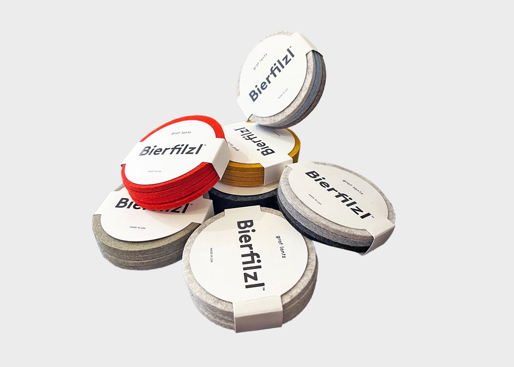 Graf Lantz Bierfilzl coasters 4 packs in a pile containing red, heather, dior, cobblestone and dijon colors.