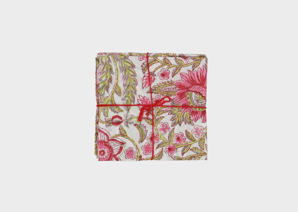
                  
                    Floral patterned fabric wrapped with a red string Gypsophil Pasteque napkins Suzette A Table
                  
                