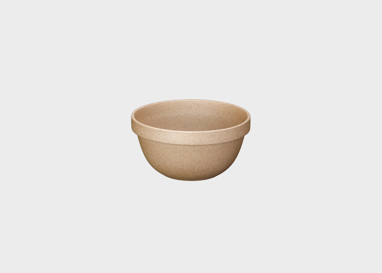 Beige ceramic bowl on a light gray background