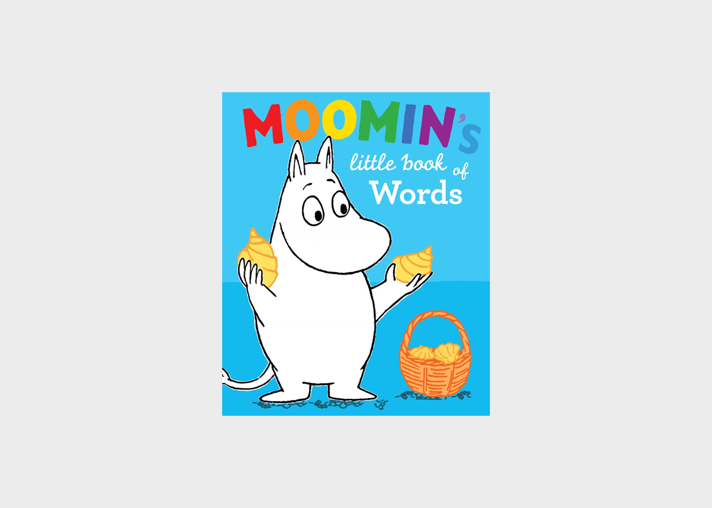 Front cover of the children's book 'Moomin's little book of Words' featuring the Moomin character on a bright blue background with colorful title text and a basket of yellow items.
