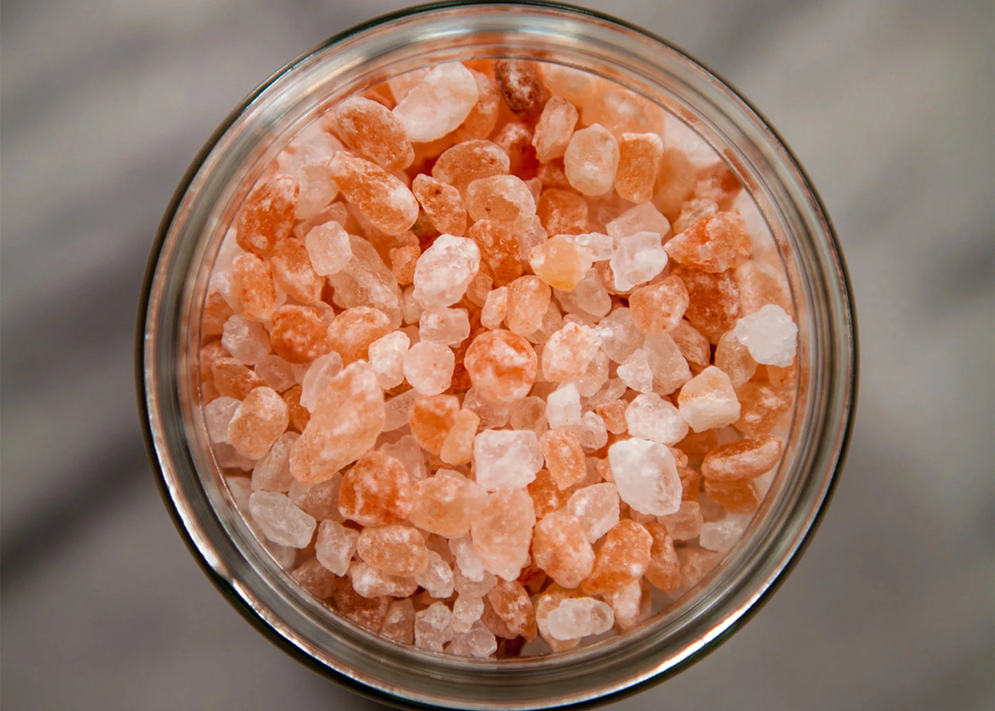 
                  
                    A close up photo of salt granules from pink himalayan sea salt by Jacobsen Salt Co. in a jar.
                  
                