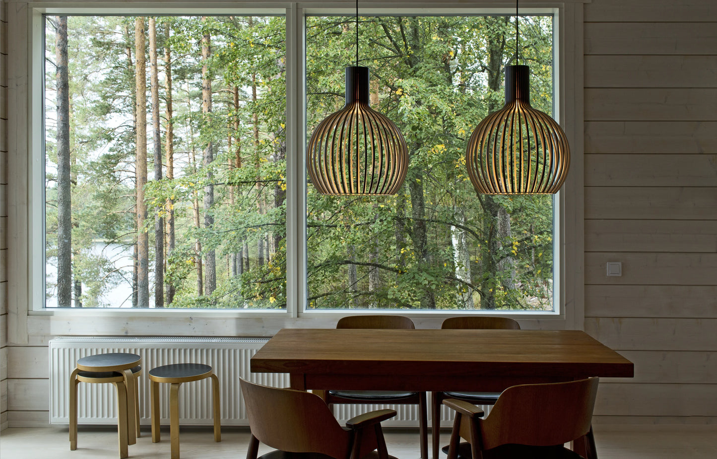 Secto Lights above a minimalist table in a home next to the woods