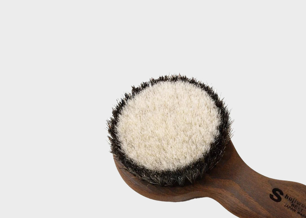 
                  
                    A close up of the Shoji Works hand held short body brush in a dark wood color as sold by Woodland mod.
                  
                