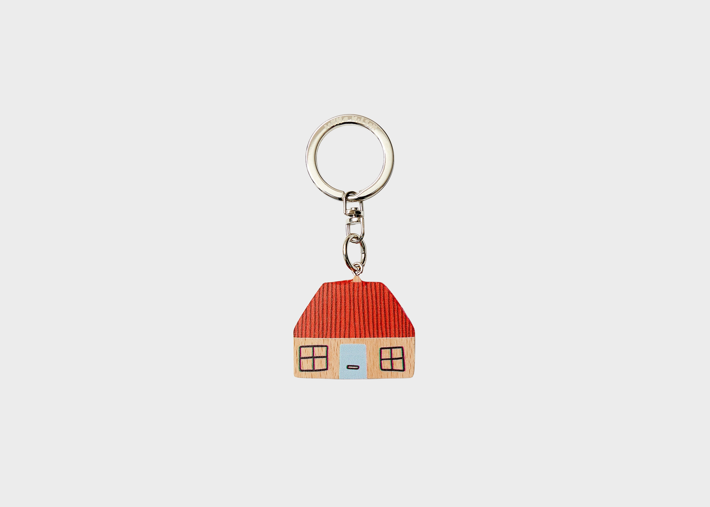 
                  
                    A small house-shaped keychain charm with a red roof, beige walls, a light blue door, and a silver metal key ring on a plain light gray background.
                  
                
