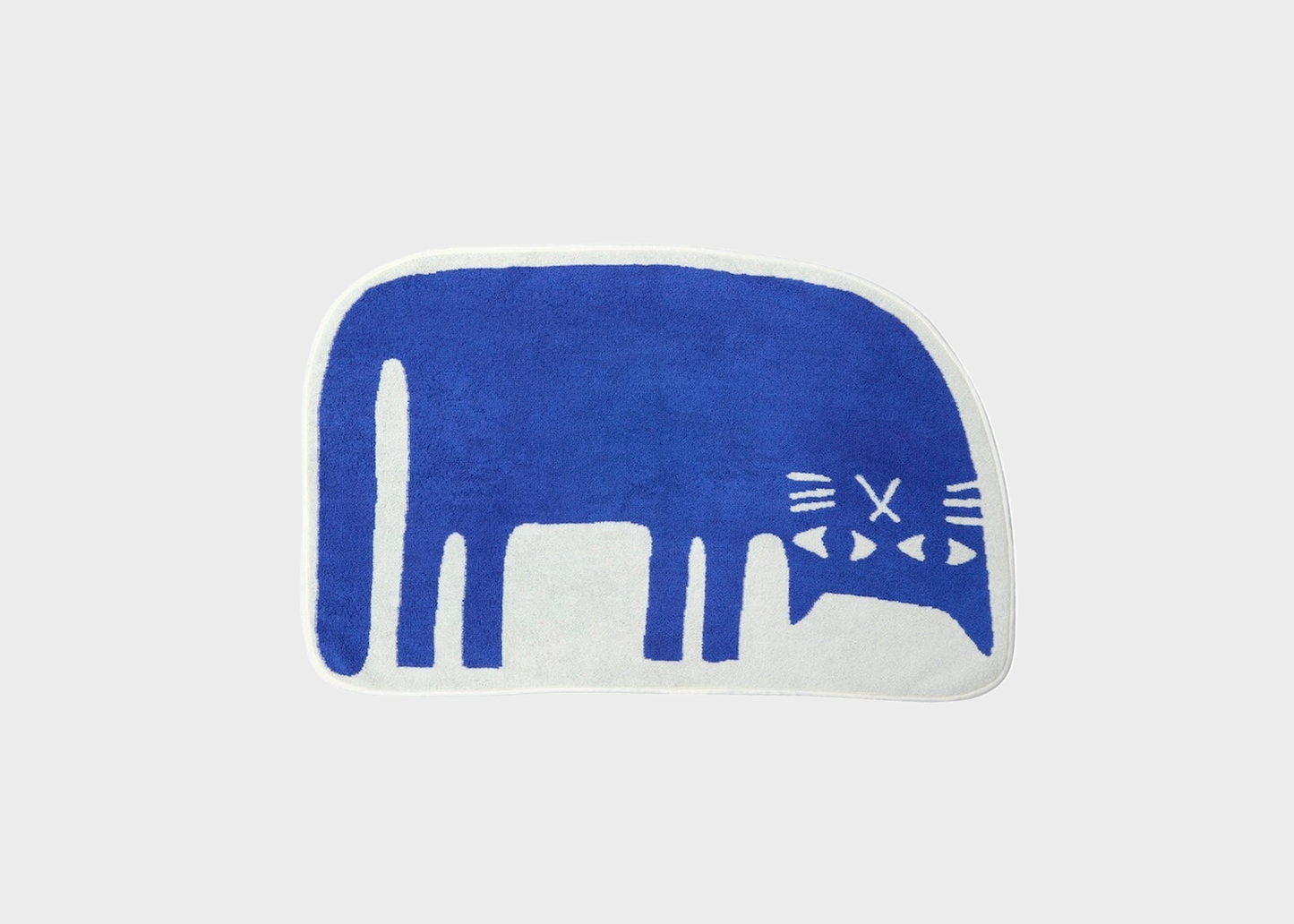 
                  
                    A blue and white cat-shaped bath mat on a light gray background.
                  
                