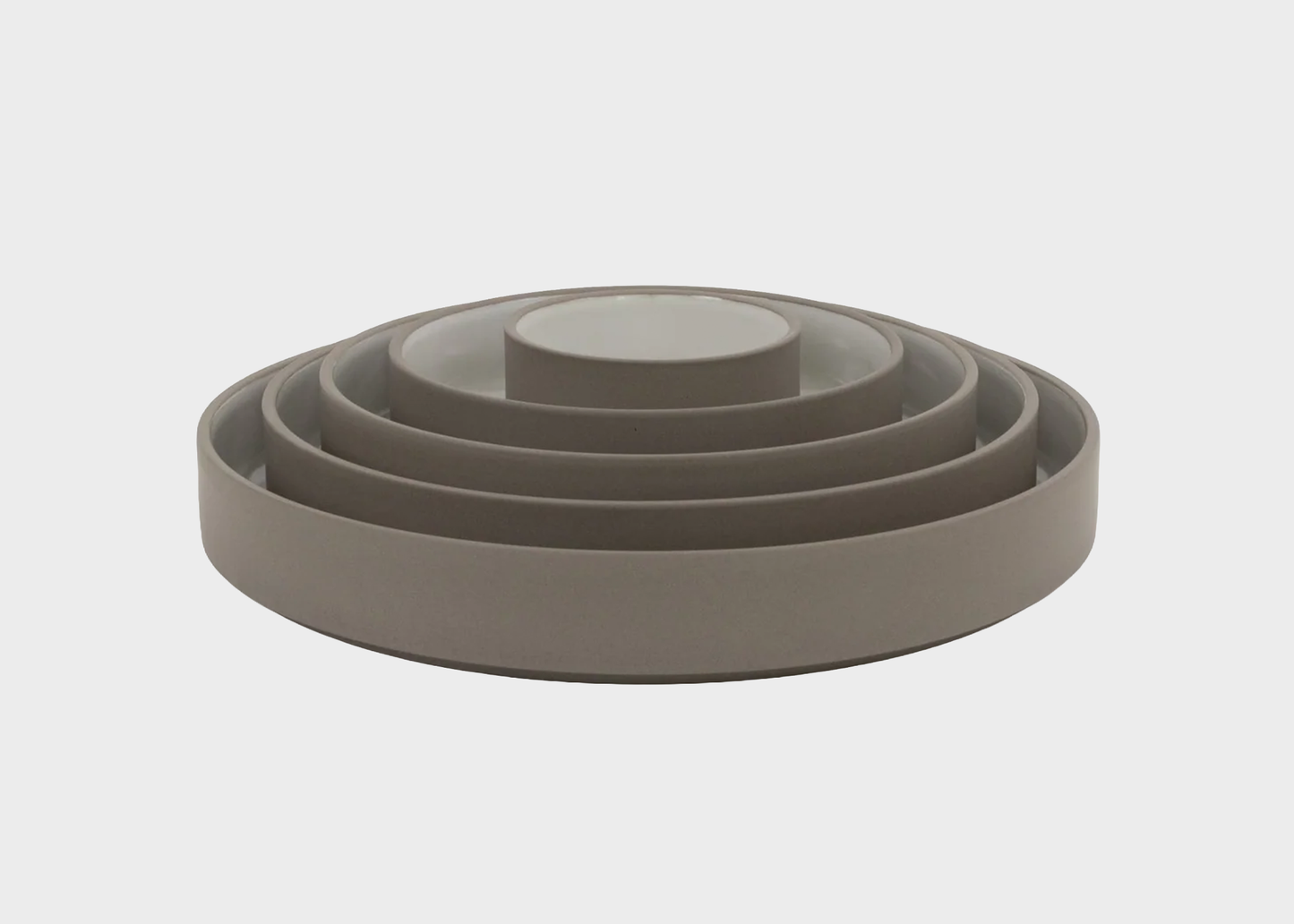 
                  
                    Set of hasami gray ceramic bowls of different sizes on a light gray background
                  
                