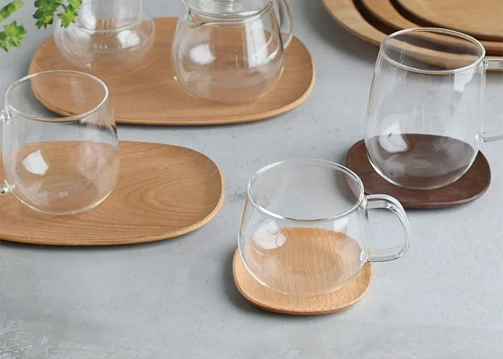 beech coaster with a clear glass mug on top
