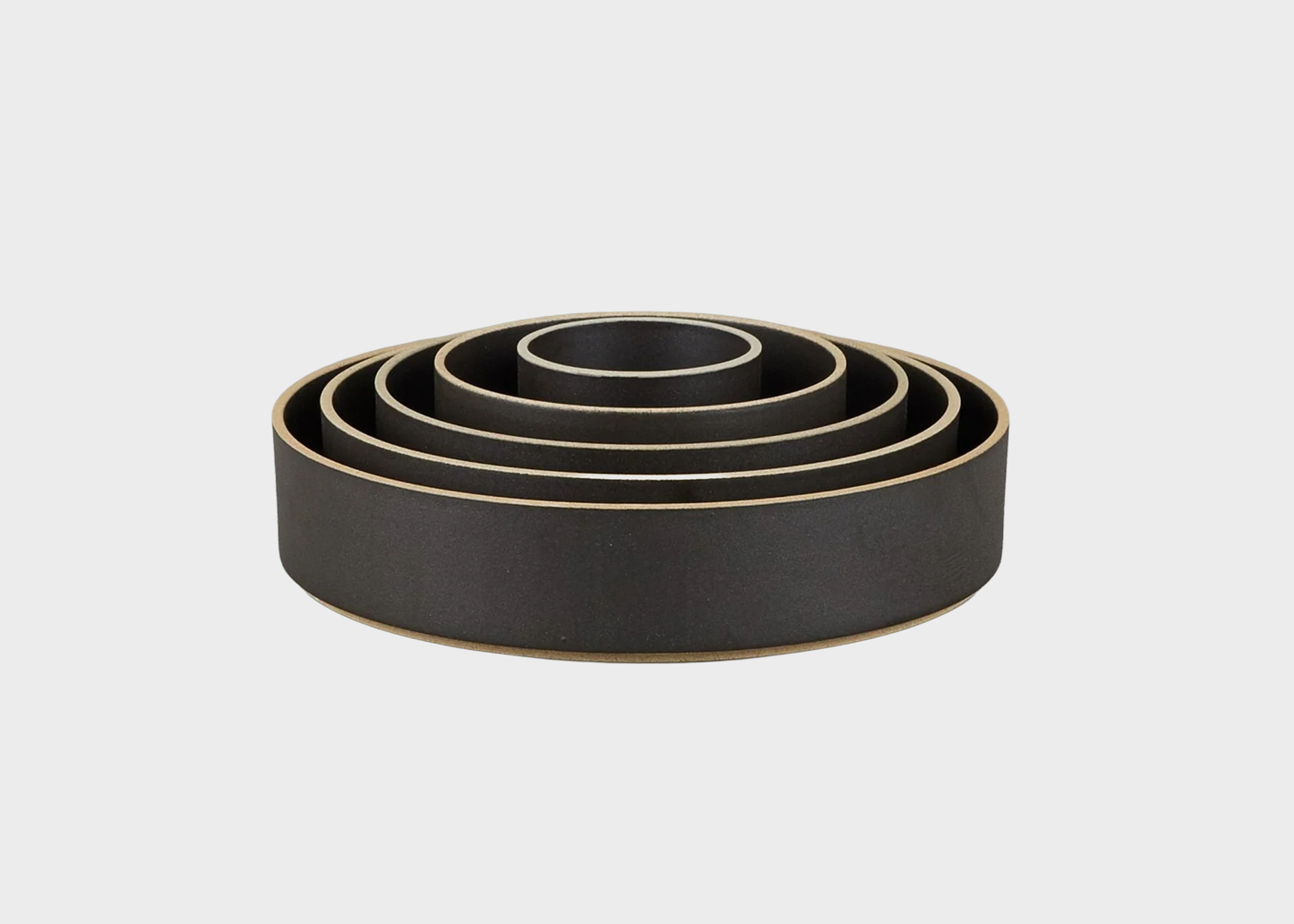 Set of black nesting bowls on a light gray background