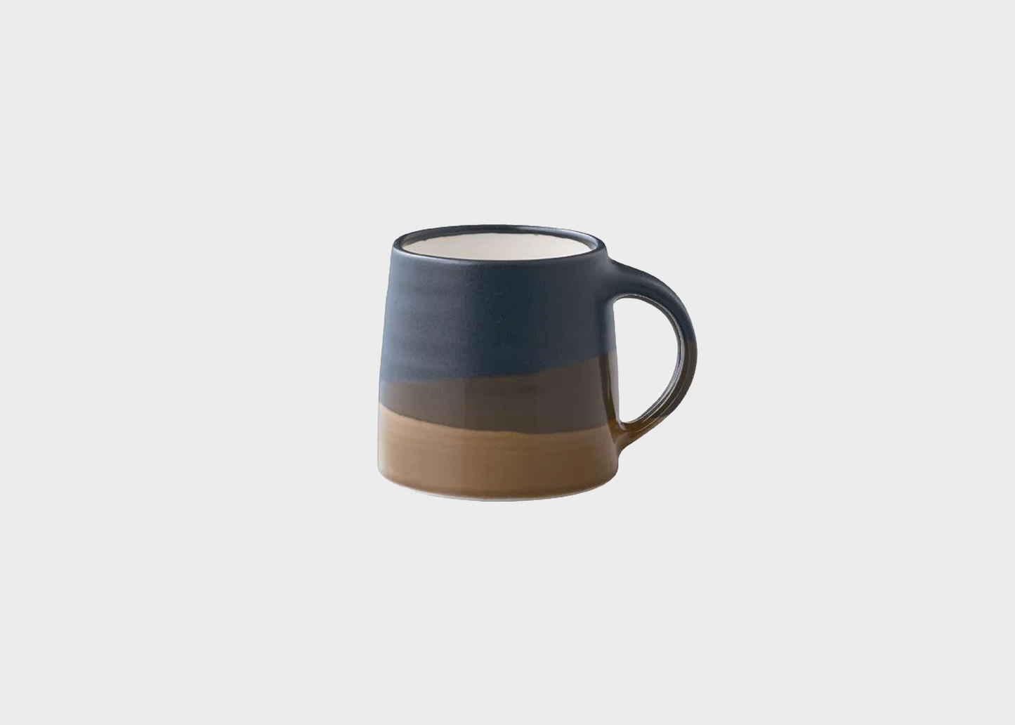 
                  
                    Two-tone ceramic mug with a gradient from blue to brown on a light gray background
                  
                