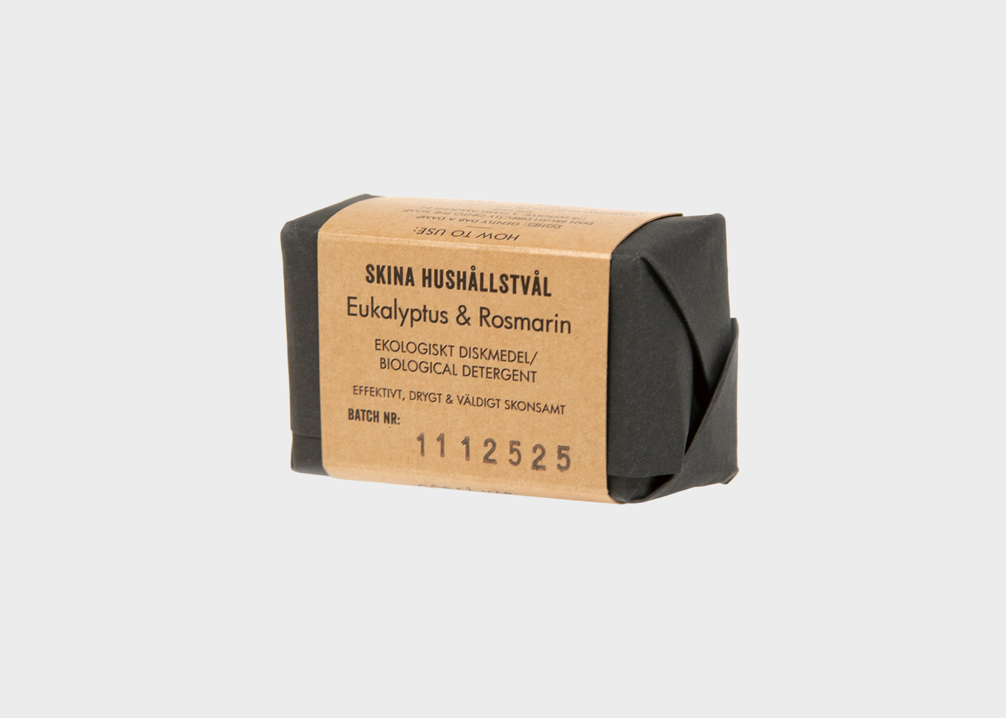 
                  
                    A wrapped bar of Iris Hantverk Eukalyptus & Rosmarin dish soap, wrapped in black paper with a tan cardboard label, on a light gray background.
                  
                