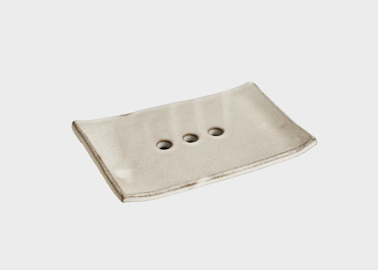 
                  
                    Rectangular beige soap dish with three holes on a light gray background
                  
                