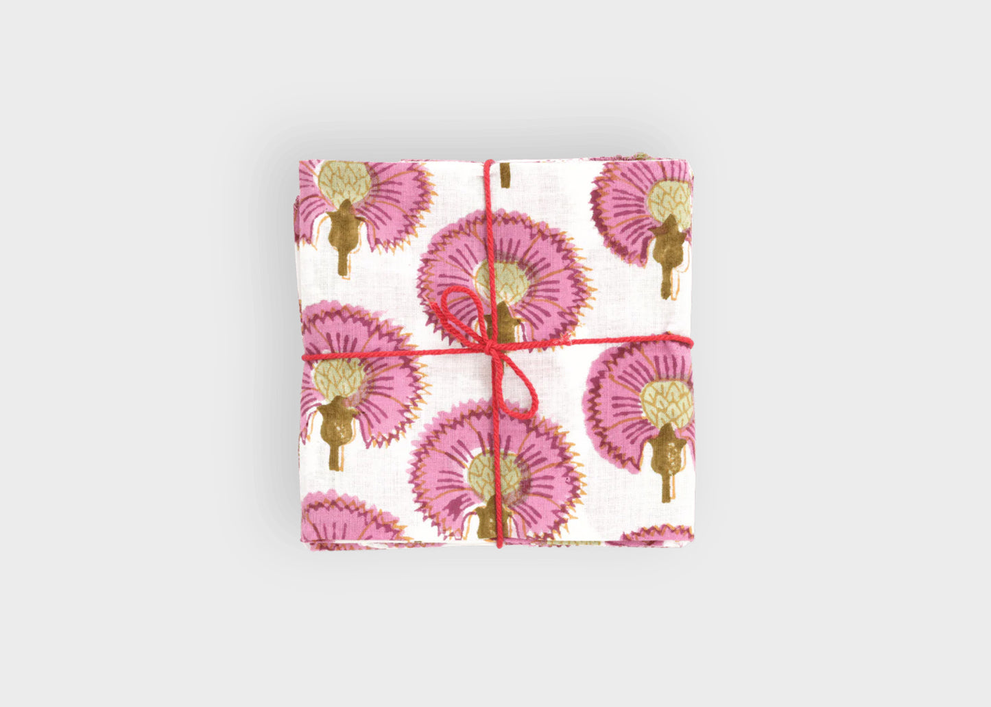 
                  
                    Gift wrapped in pink floral patterned paper with red ribbon on a light gray background cosmos napkins set suzette a table
                  
                
