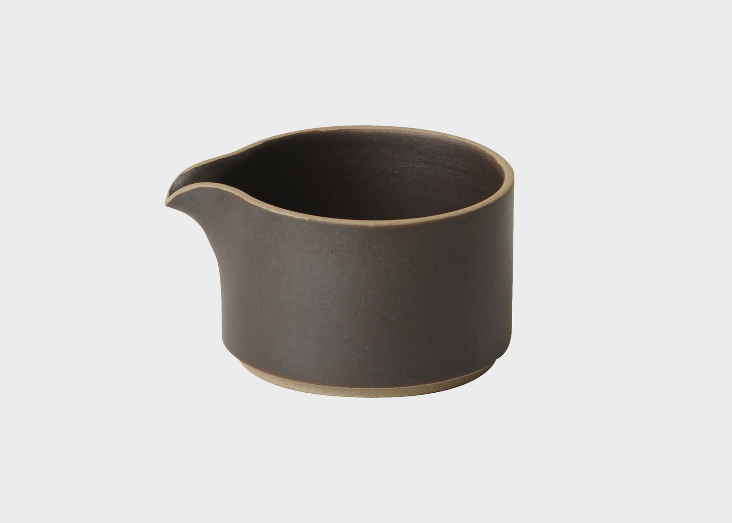 Black ceramic creamer pitcher on a white background