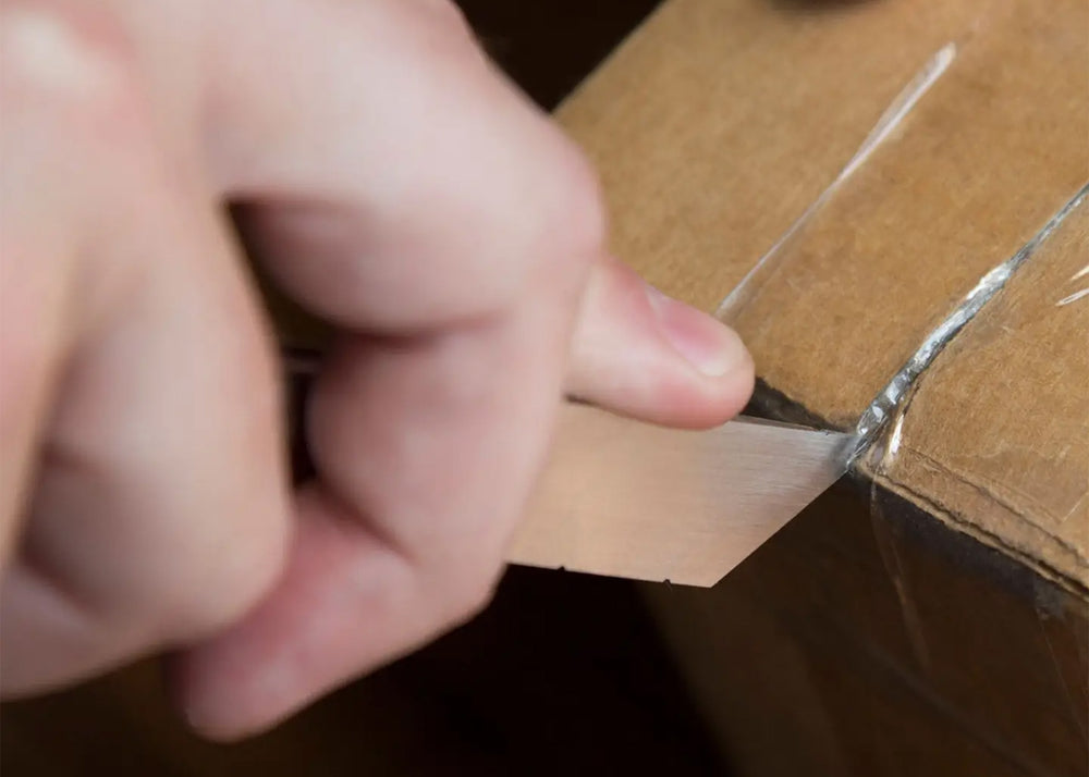 
                  
                    Desk Knife by Craighill in stainless steel cutting open a box
                  
                