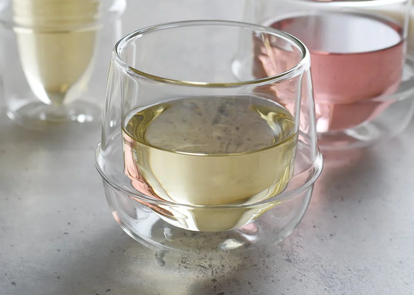 
                  
                    Clear glass cup with white liquid on a light surface
                  
                