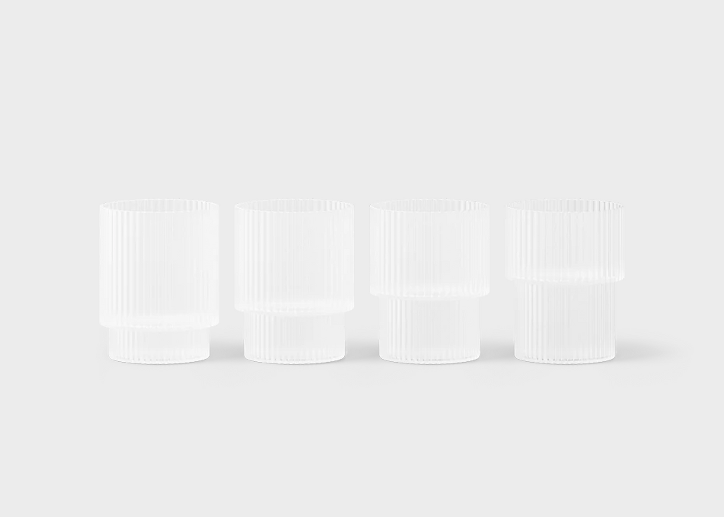 
                  
                    Four frosted white ripple glass containers on a light gray background
                  
                
