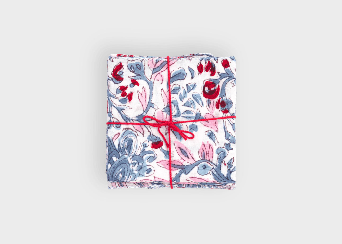 
                  
                    Packaged product with floral design and red string ginkgo vista napkins Suzette a table
                  
                