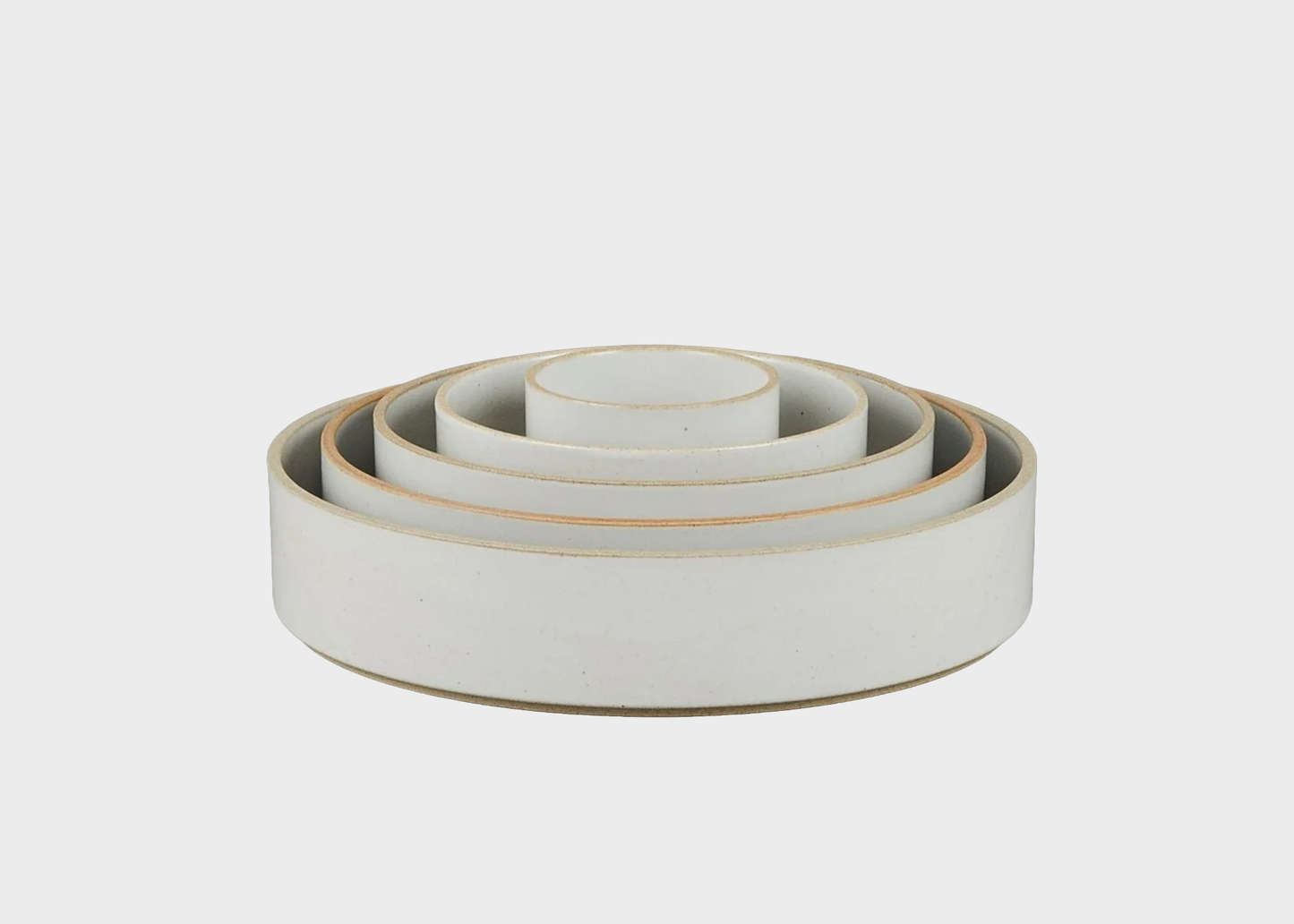 
                  
                    Set of white ceramic bowls with ceramic rims on a light gray background
                  
                