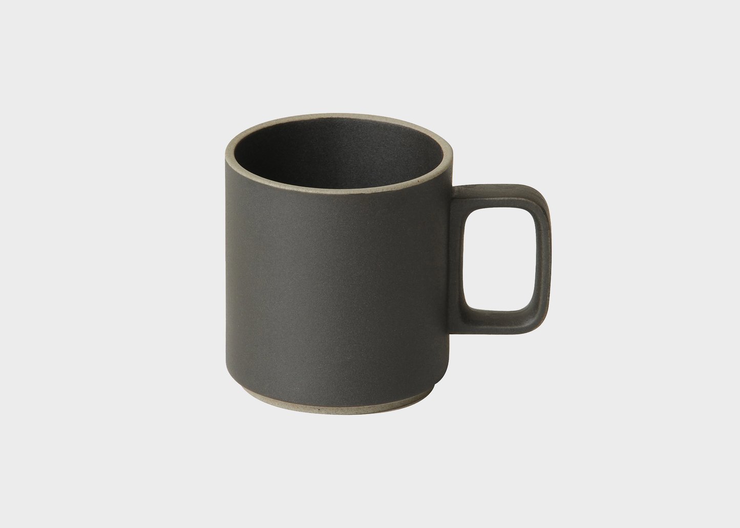 black ceramic mug on a light gray background