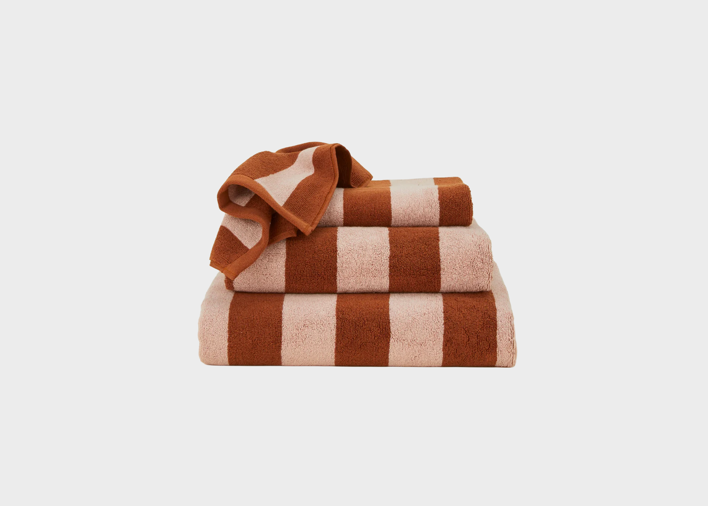 
                  
                    Stack of red and pink striped towels on a white background
                  
                