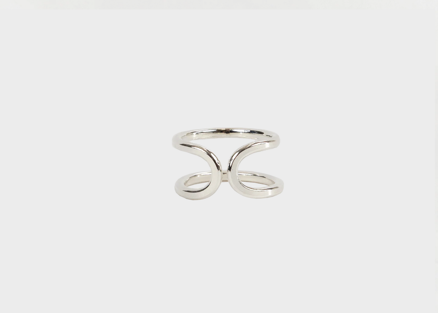 Silver ring by Cameron Rando on a light gray background