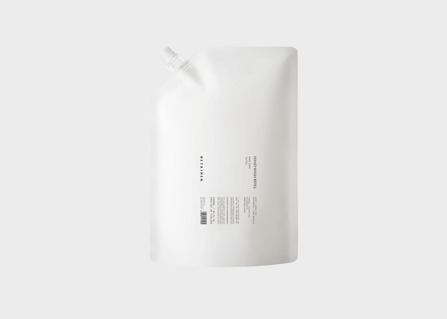 White bottle with a label on a light gray background