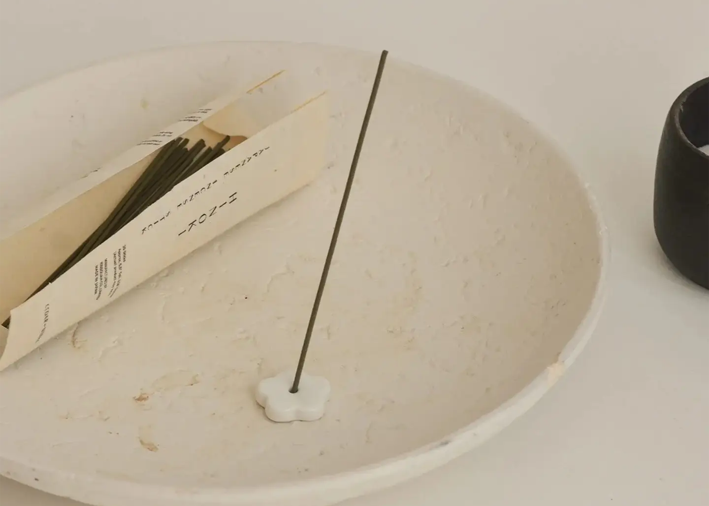 
                  
                    Incense stick with packaging on a white surface
                  
                