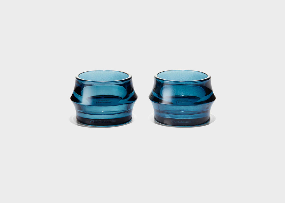Two blue glass tumblers on a white background