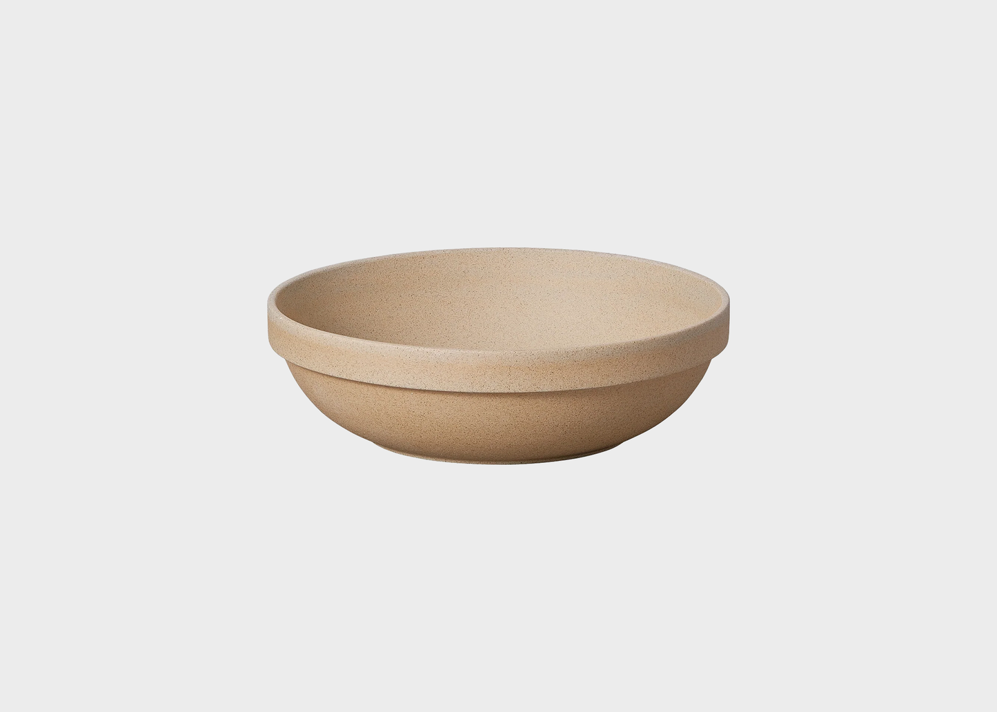 Beige ceramic bowl on a light gray background