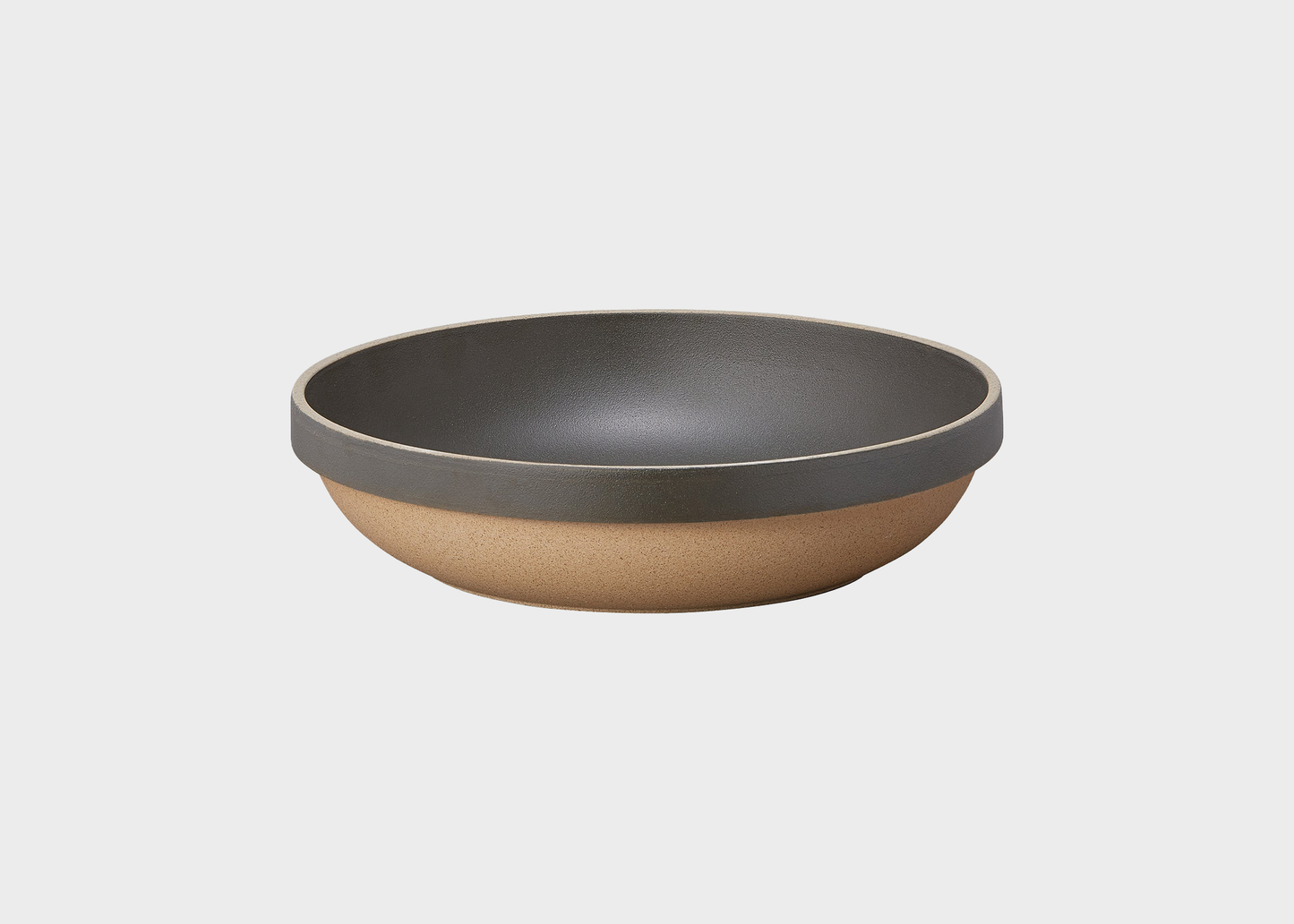 
                  
                    Two-tone bowl with dark gray top and brown bottom on a light gray background
                  
                