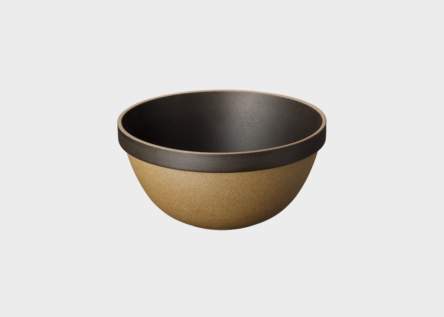 
                  
                    Bowl with black interior and brown exterior on a white background
                  
                