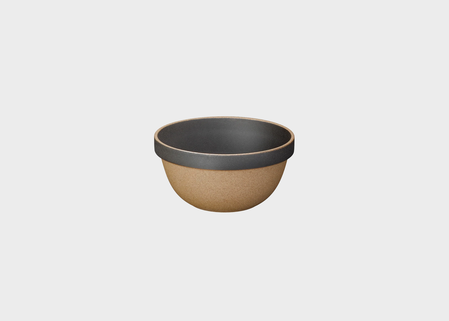 Ceramic bowl with black interior on a light gray background