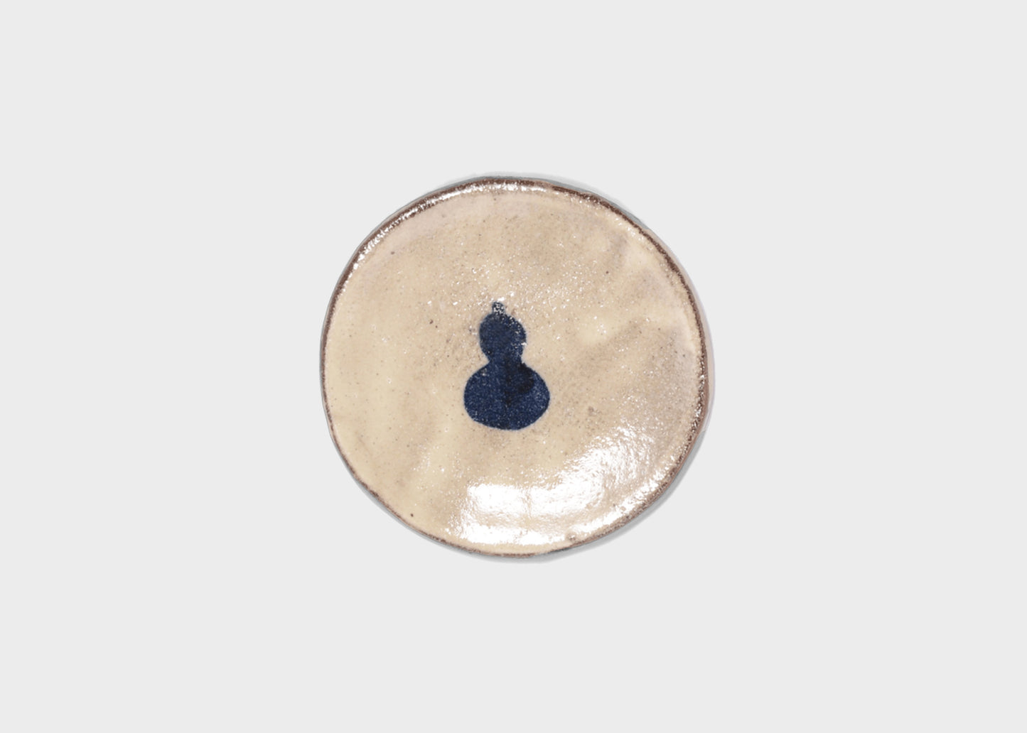 Small ceramic plate with a blue design on a light gray background