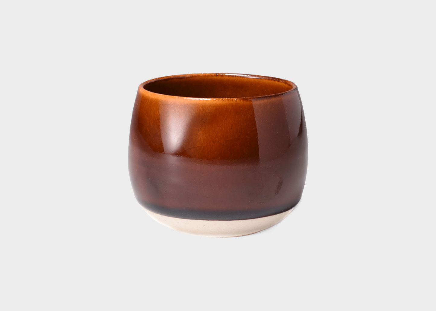 
                  
                    Brown ceramic tea cup on a light gray background
                  
                