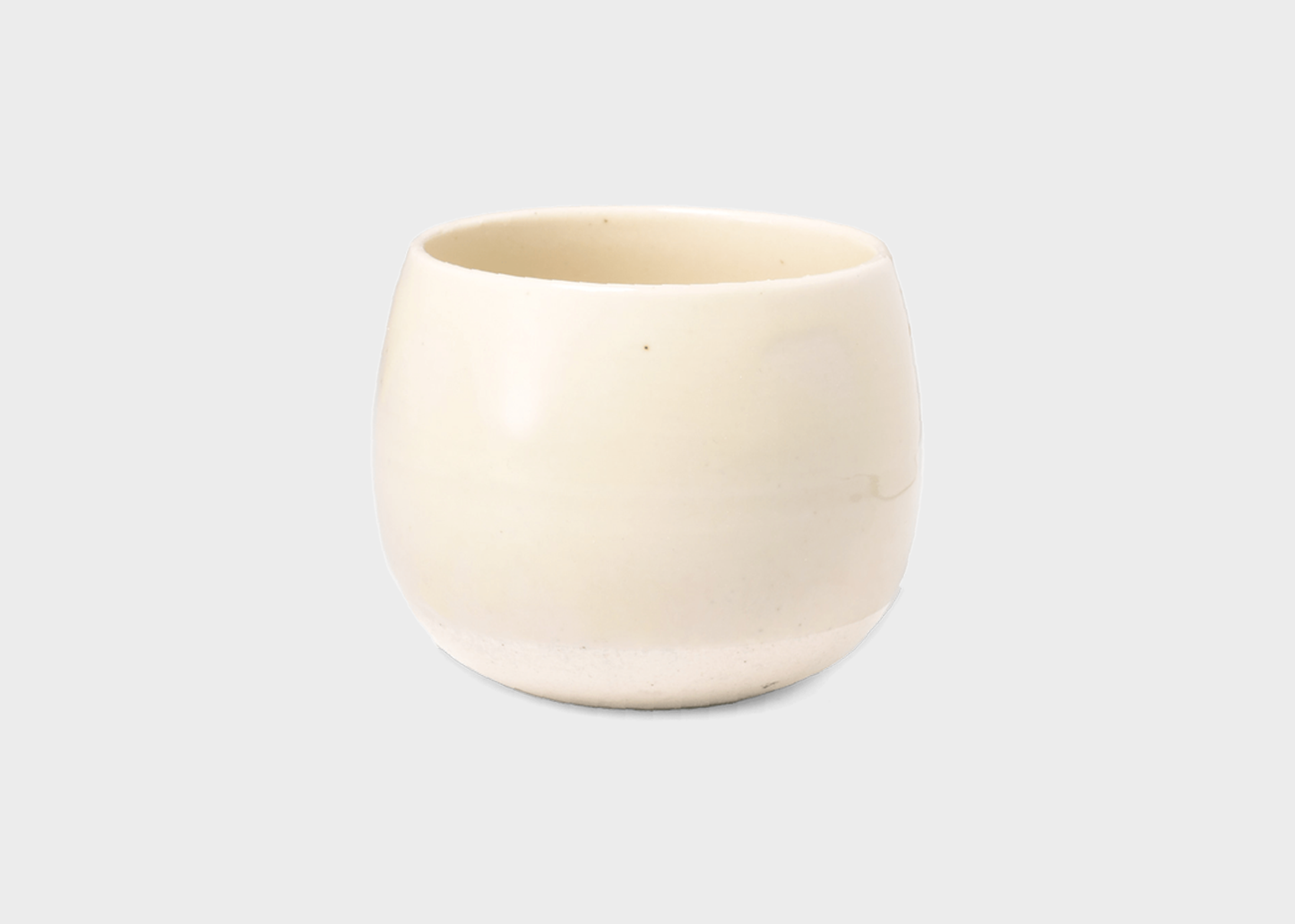 
                  
                    Beige ceramic tea cup on a light gray background
                  
                