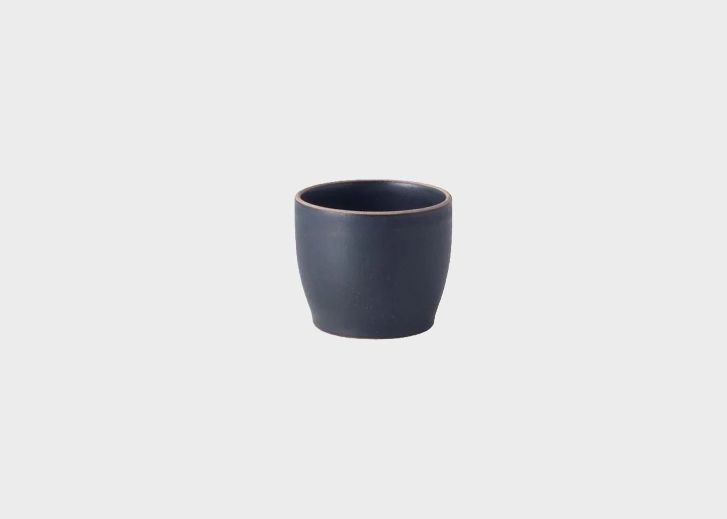 Dark blue ceramic cup on a light gray background