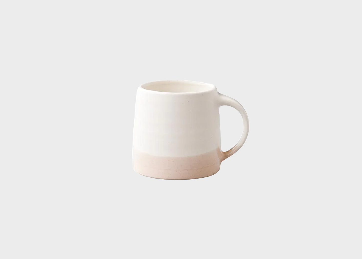 
                  
                    White and pink ceramic mug on a light gray background
                  
                
