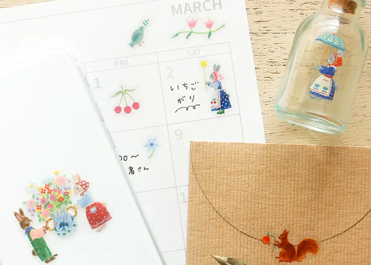 
                  
                    Calendar with decorative stickers and a glass bottle on a wooden surface
                  
                