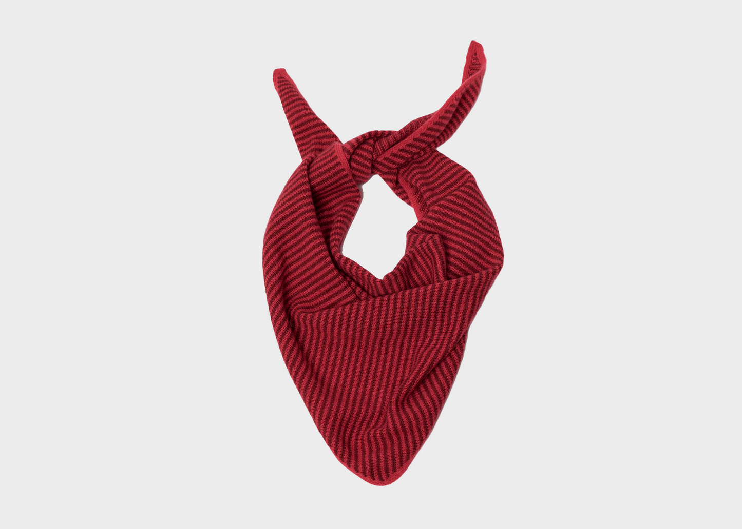 Red knotted cashmere triangle scarf on a light gray background