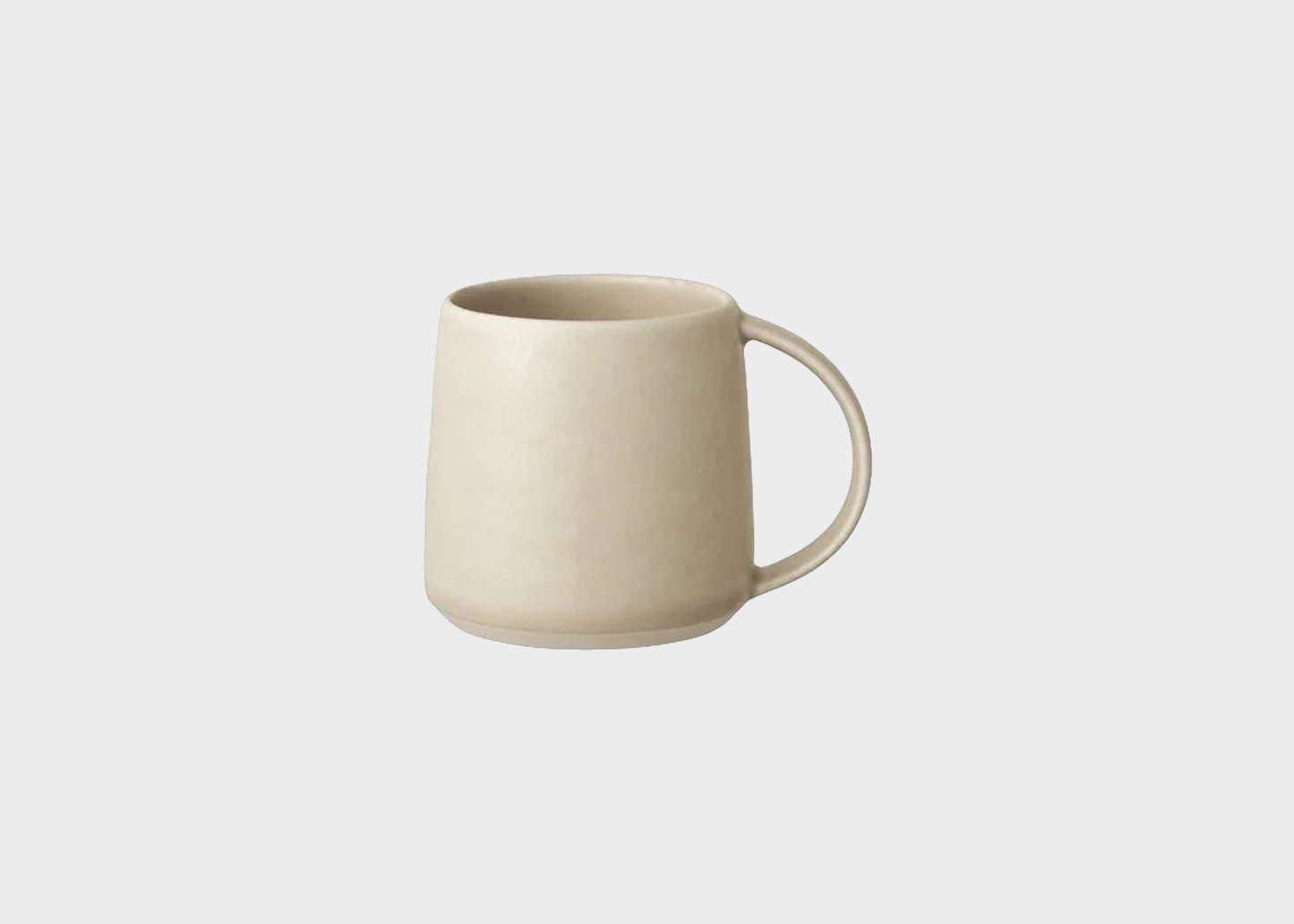 
                  
                    Beige ceramic mug on a light gray background
                  
                