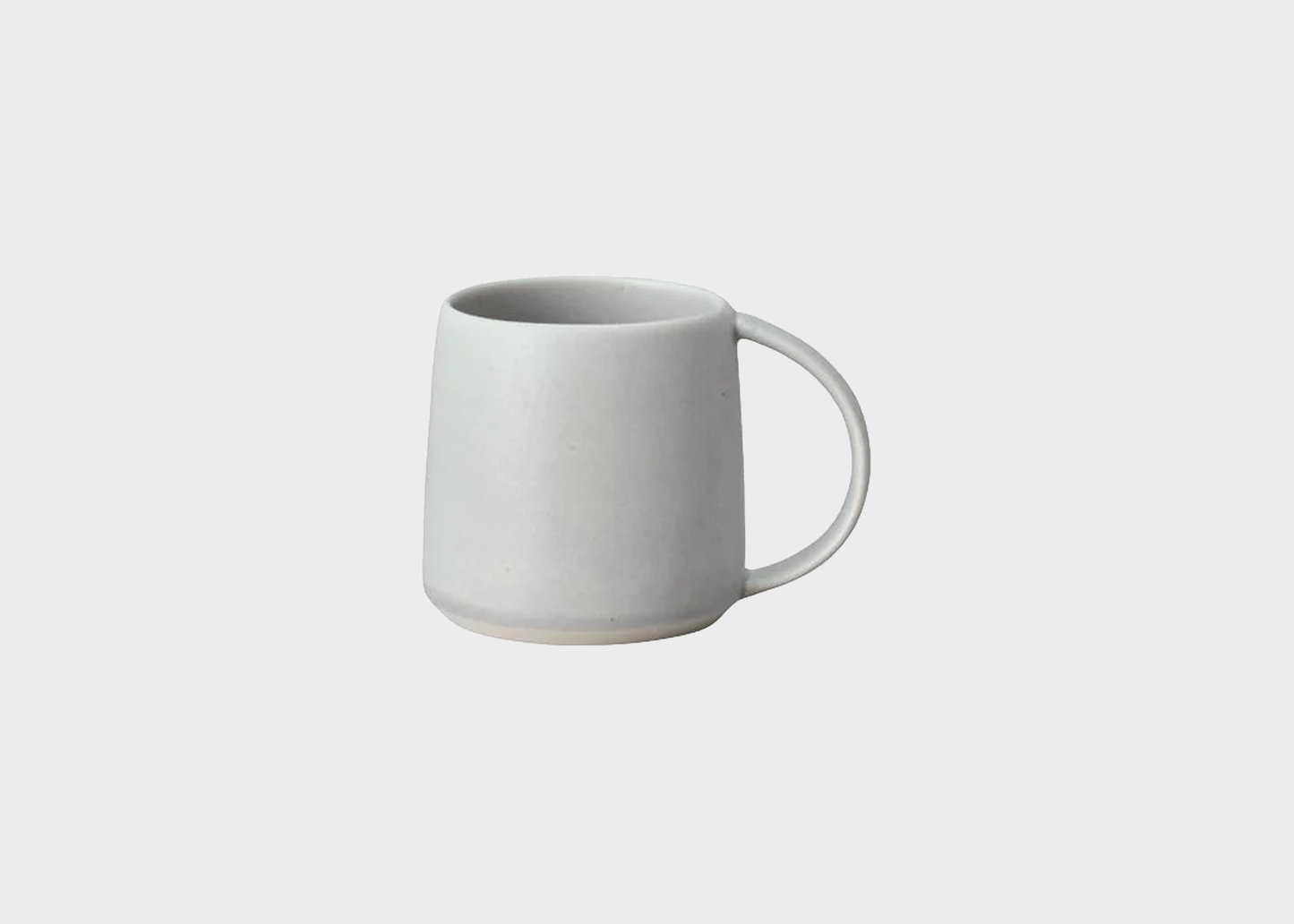 
                  
                    White ceramic mug on a light gray background
                  
                